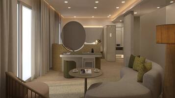 A modern hotel room with a sofa, a round table, a large mirror, and a reception desk.