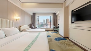 A hotel room with two beds, a TV, a desk, and a view of the city. - Xana Lite Hotel (Guangzhou)