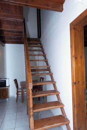 A wooden staircase leading to an upper floor in a residential setting.