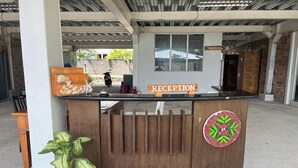 A reception desk with a sign indicating a restroom. - Saga Village Hotel and Resort Bintan (Bintan)
