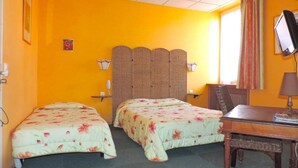 A room with two beds, a desk, a chair, a television, and a window with curtains. - Adonis Digne Hotel Particulier (Digne-les-Bains)