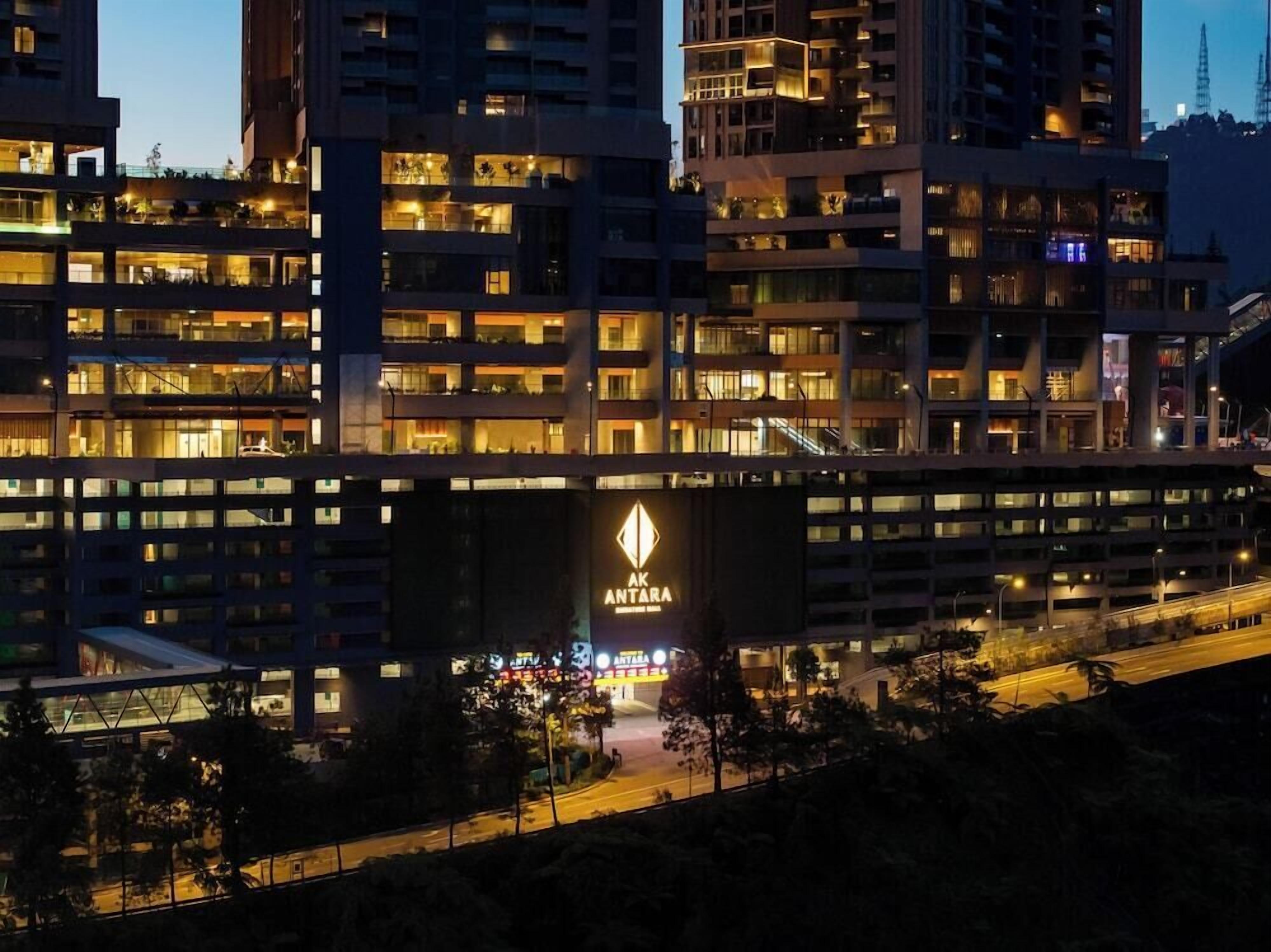 A multi-story building with a prominent sign reading 'AK ANTARA' at the entrance.