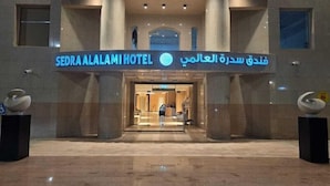 The entrance to Sedra Alalami Hotel with a modern design, featuring a prominent entrance and a clear view into the lobby area. - Sedra Al Aalami Hotel (Madinah)