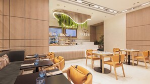 A modern restaurant interior with wooden panel walls, a central counter with a menu display, and seating areas with tables and chairs. - Holiday Inn Dubai Village Circle (Dubai)