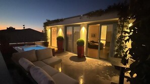 A modern outdoor living area with a pool, seating, and a glass-enclosed space. - Juno Residences (Istanbul)