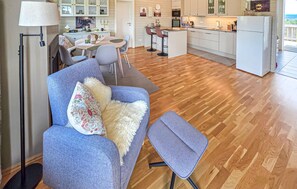A modern living room with a sofa, a small table, and a lamp. - Amazing apartment in . Gol with sauna (. Gol)