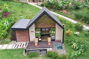 A modern house with a large deck, a swimming pool, and lush garden surroundings. - Macana Eco Hotel (Montenegro)