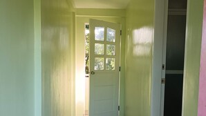 A hallway with a patterned floor, a door with windows, and a closet with a sliding door. - Fully furnished house, a café & pool in a forest! (Naujan)