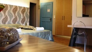 A room with a bed, a desk, a chair, and a wardrobe. - Lassia Hotel (Lesvos)