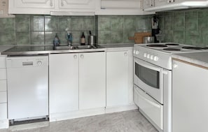 A kitchen with white cabinets, a dishwasher, a stove, and a sink. - 3 bedroom gorgeous home in Visby (Visby)
