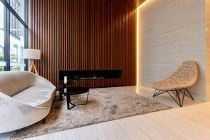 A modern interior with a piano, a cushioned chair, and a lamp. - Modern 2BR Coworking Yoga Studio WiFi (San Isidro)