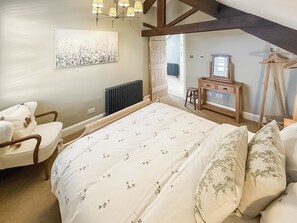 A bedroom with a bed, a chair, a desk, and a radiator. - 2 bedroom accommodation in Langsett Reservoir (Langsett Reservoir)