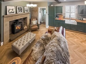 A living room with a fireplace, a sofa, and a dog. - 2 bedroom accommodation in Langsett Reservoir (Langsett Reservoir)