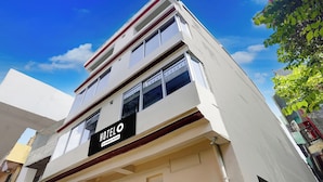 A multi-story building with a sign reading 'HOTEL & company-serviced'. - Hotel O Prayagraj Sangam Railway (Prayagraj)