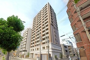 A multi-story building with a modern architectural design, featuring a flat roof and a uniform facade. - 1 min walk from sta./Excellent access to central (Osaka)