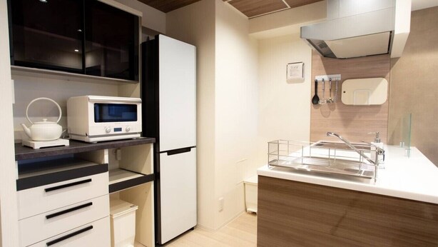 A modern kitchen with a microwave, kettle, and refrigerator. - 1 min walk from sta./Excellent access to central (Osaka)