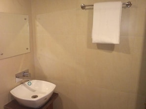 A bathroom with a white sink, a towel rack, and a mirror. - Hotel Paras By TWC hotels (Jabalpur)