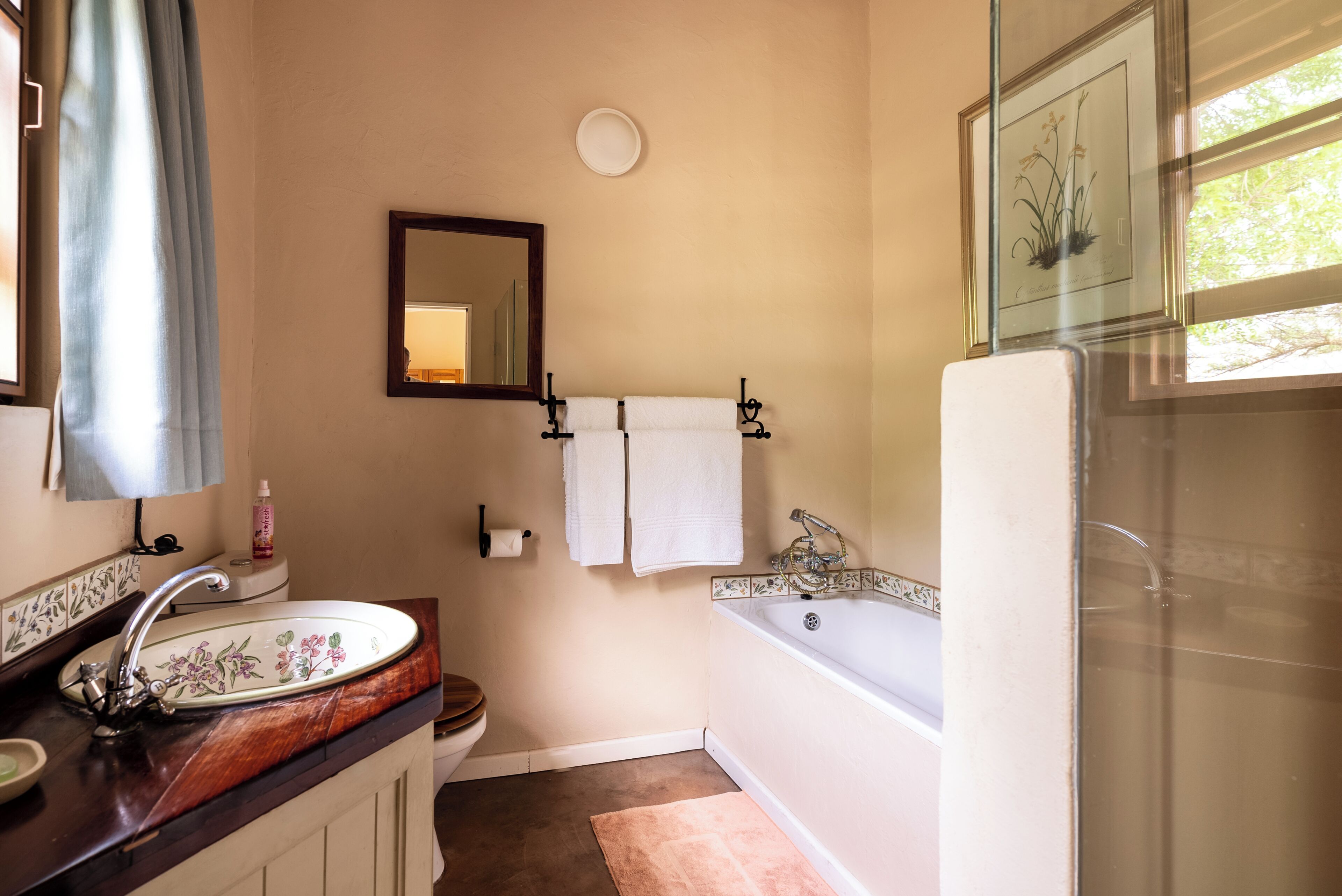 A bathroom with a sink, mirror, toilet, bathtub, and a shower.