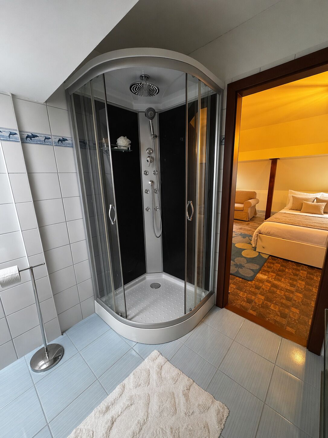 A modern bathroom with a glass-enclosed shower, a toilet, and a sink.