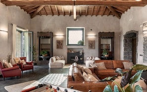 A spacious living room with a high ceiling, a fireplace, and a large window. - Elegant 4 Bedroom Private Pool Villa in Acireale (Acireale)