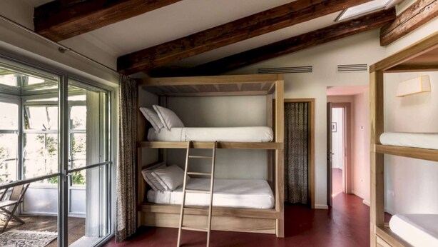 A bunk bed room with a ladder, a window, and a door. - Large Orbetello Villa with Private Pool (Orbetello)