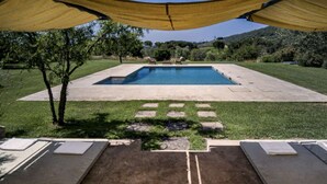 A swimming pool with a surrounding deck and a covered area with a view of the landscape. - Large Orbetello Villa with Private Pool (Orbetello)