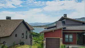 A residential area with houses, a garage, and a view of a lake and mountains. - Hot Tub, Mtn & Lake Views! Group Abode in Daniel (Daniel)