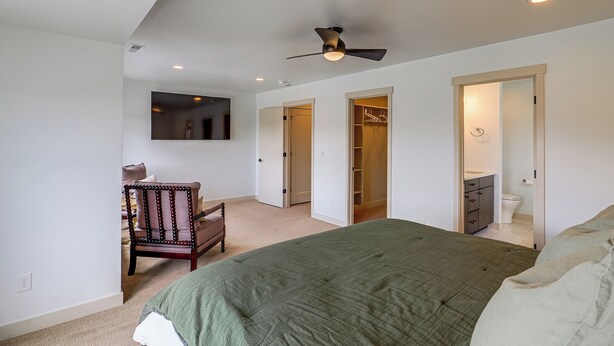 A bedroom with a bed, a chair, a closet, and a bathroom. - Hot Tub, Mtn & Lake Views! Group Abode in Daniel (Daniel)
