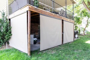 A covered outdoor space with a wooden deck, a metal railing, and a potted plant. - Hot Tub+Game Room, 8 Ski resorts + SLC | Sleeps 14 (Centerville)