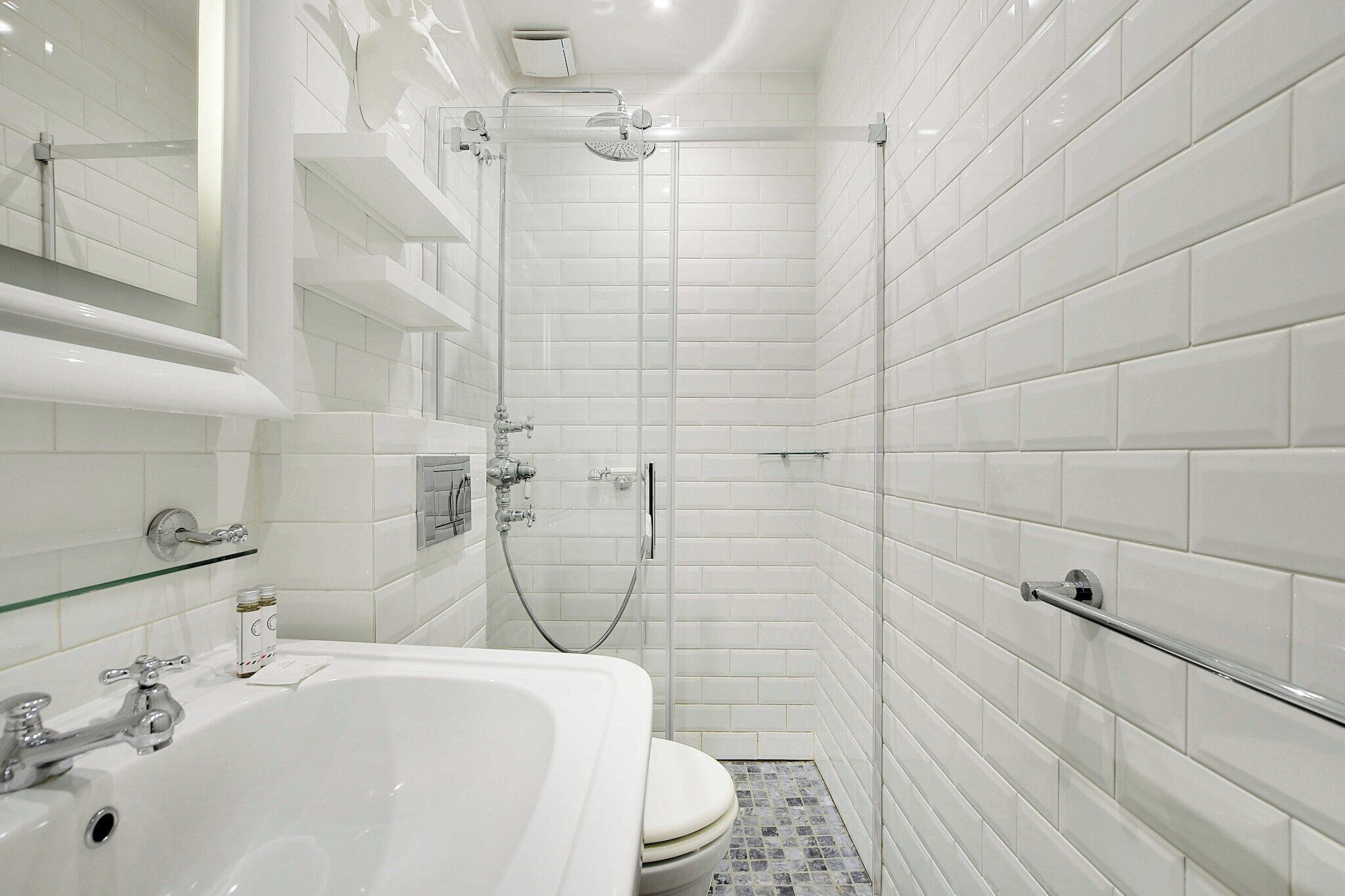 A modern bathroom with a bathtub, shower, and toilet.