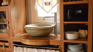 A wooden kitchen with a large bowl sink, a cabinet with dishes, and a towel rack. - Pretty little Picardy house by the water (Epagne-Epagnette)