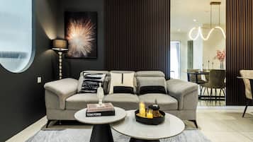 A modern living room with a sofa, a round coffee table, and a floor lamp.