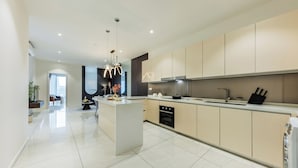 A modern kitchen with a central island, built-in oven, and stainless steel appliances. - Veone Hotel  Kuala Lumpur (Kuala Lumpur)