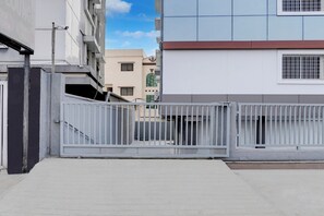 A gated entrance to a building with a metal gate, a concrete pathway, and a clear sky. - Super Collection O Omkar Nagar Nagpur (Nagpur)