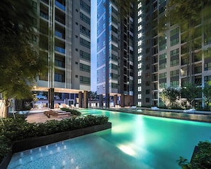 A modern hotel with a rooftop pool, multiple floors, and a well-lit outdoor area. - Pattaya Central Excellent 1 Bed Room Best Location (Muang Pattaya)