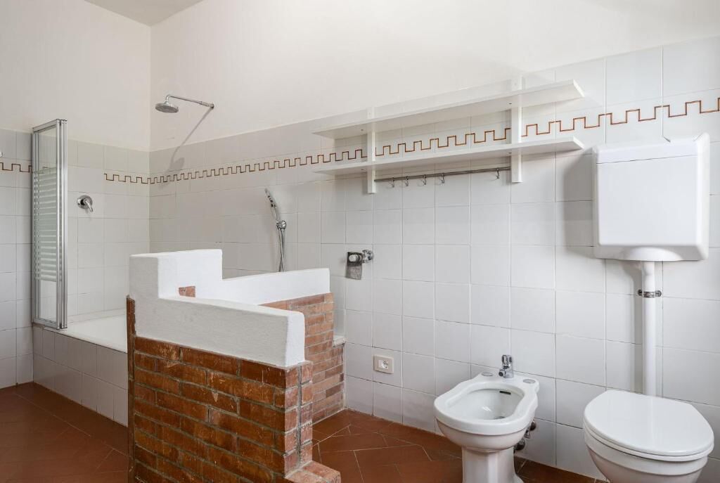 Ein Badezimmer mit Dusche, Toilette und Bidet.