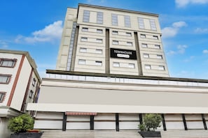 A multi-story building with a sign that reads 'TOWNHOUSE Company Serviced.'