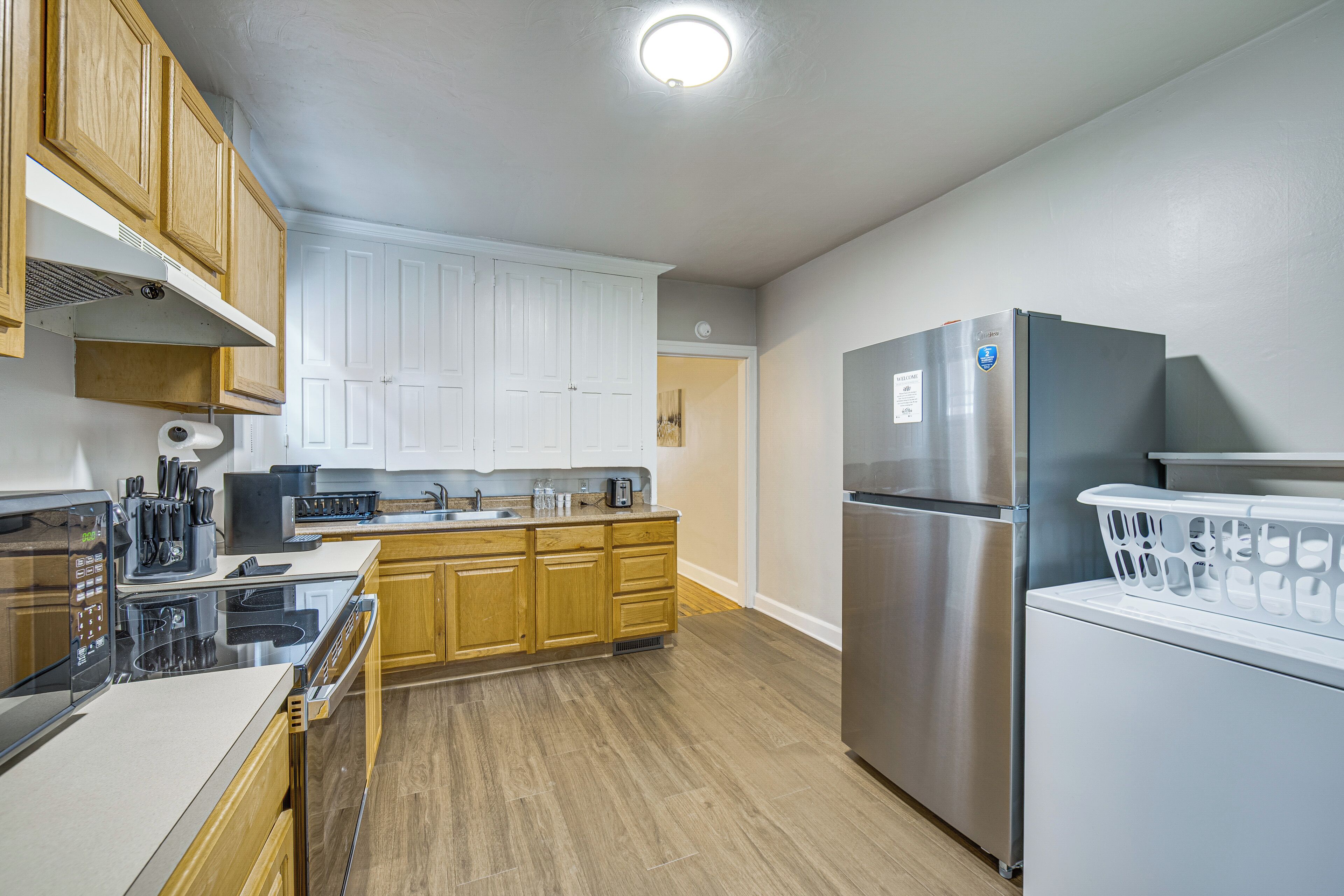 A modern kitchen with wooden cabinets, stainless steel appliances, and a central island.