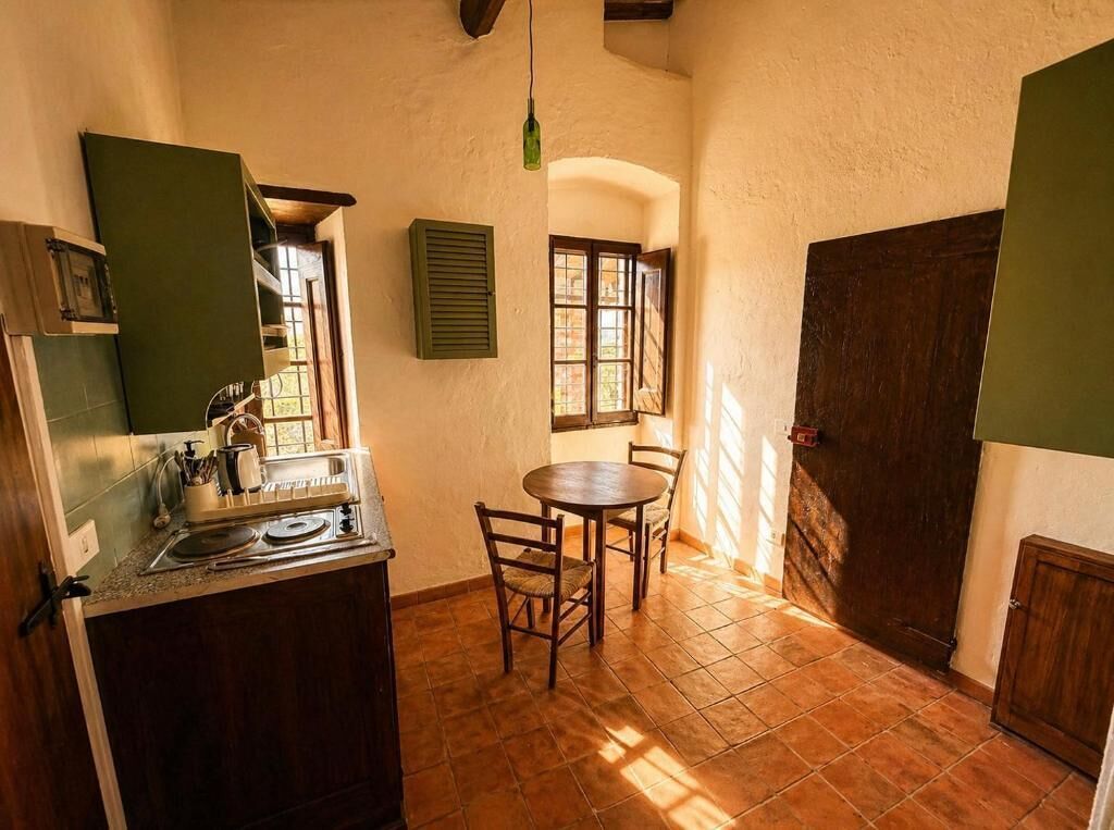 A kitchen with a dining table, chairs, and a window.