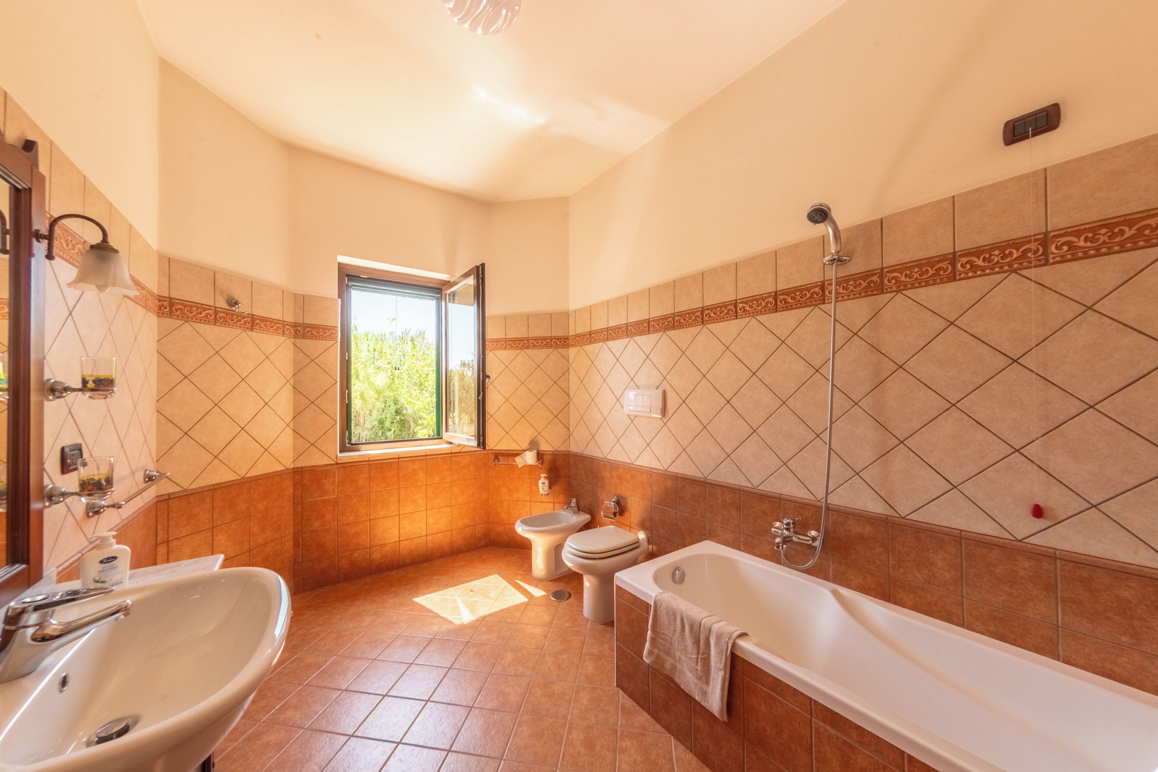 A bathroom with a bathtub, toilet, and sink.