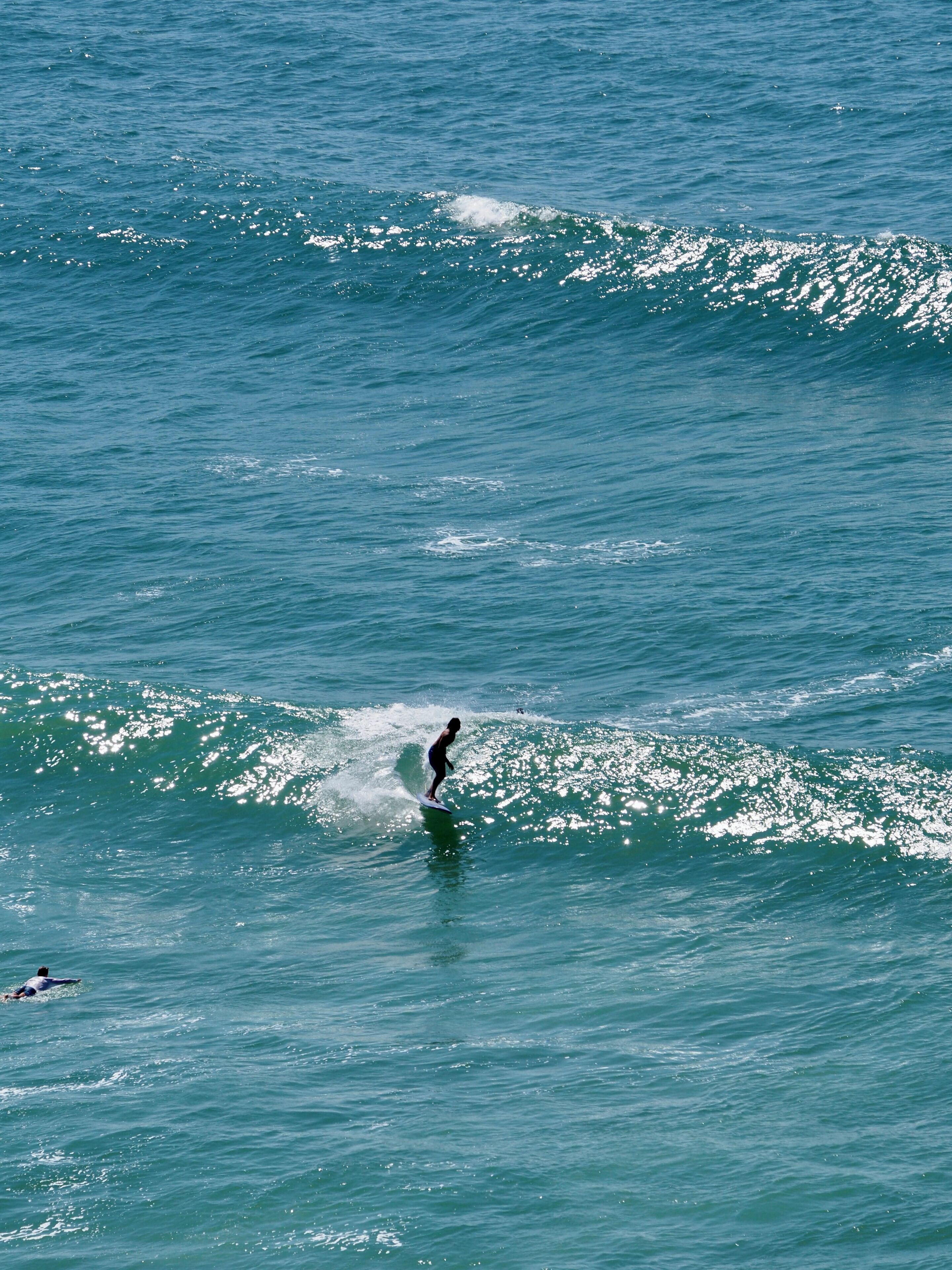 A person surfing on a wave in the ocean.
