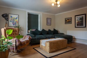 A living room with a sofa, armchair, and a wooden coffee table. - Bealtaine (Síor Collection) (Carrick-On-Shannon)
