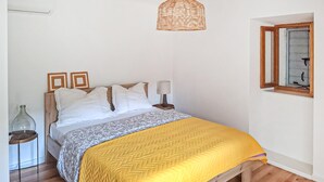 A bedroom with a bed, bedside tables, a hanging light fixture, and a window. - Lovely home in Kucice with house a panoramic view (Kucice)