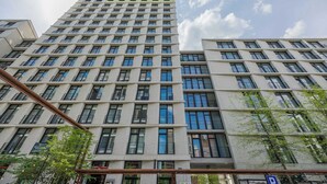 A high-rise building with a grid of windows and balconies, likely a hotel or apartment complex. - Stylish Studios with Balconies | Close to the Underground | City Centre (Warszawa)