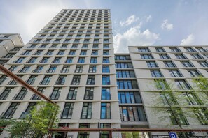 A high-rise building with a grid of windows and balconies, likely a hotel or apartment complex. - Stylish Studios with Balconies | Close to the Underground | City Centre (Warszawa)