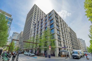 A multi-story building with a modern architectural design, featuring balconies and large windows. - Stylish Studios with Balconies | Close to the Underground | City Centre (Warszawa)