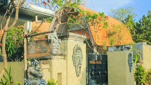 A building with a traditional architectural style, featuring a tiled roof and a decorative gate. - The Box Paradise Bungalow (Penida Island)