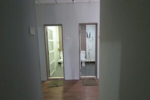 A hallway with two doors leading to a bathroom and a toilet room. - Ap Classic Hotel (Alor Setar)