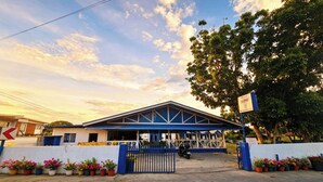 A building with a blue roof and a gated entrance.