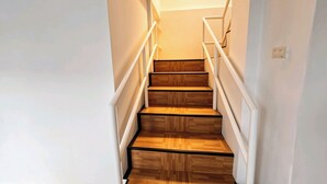A staircase with wooden steps and white railings.